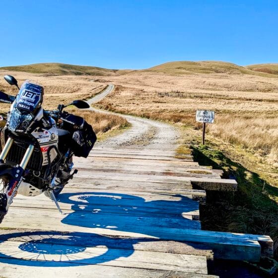 Motorbike on a makeshift wooden bridge during one of Billy's Bike Adventures